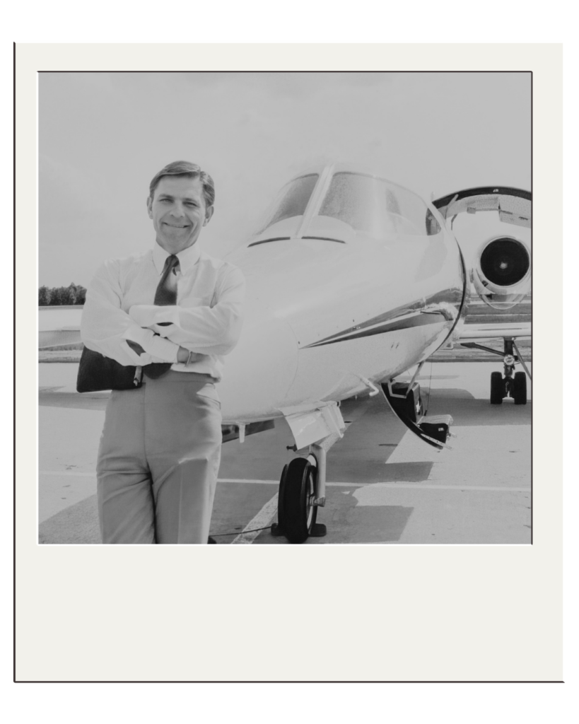 Polaroid picture of a man in front of an airplane.